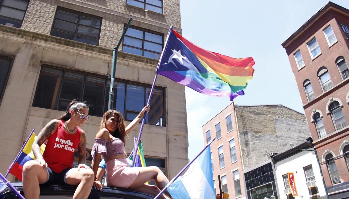 A picture of TINGS program manager holding Philadelphia Pride Flag